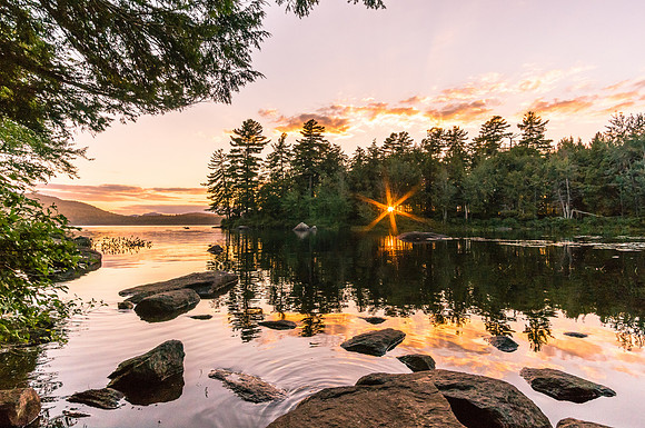 20150822-DSC8231: The sun dips below treeline at Sacandaga Lake in Speculator NY Adirondacks.