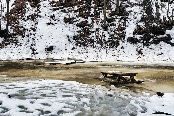 20190204-JAH06411: A picnic table gets swept into Grimes Creek in Naples NY.