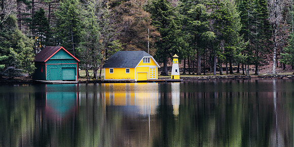 20190502-JAH07606: Yellow boat house & lighthouse in Old Forge NY Adirondacks (2x1 size)