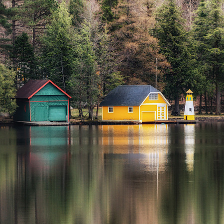 20190502-JAH07623: Yellow boat house & lighthouse in Old Forge NY Adirondacks (Square)