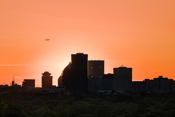 20190623-JAH07633: A plane flies past Rochester NY during a luminous sunset.